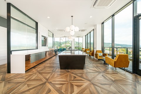 A long hallway with a wooden floor and chairs on the side.