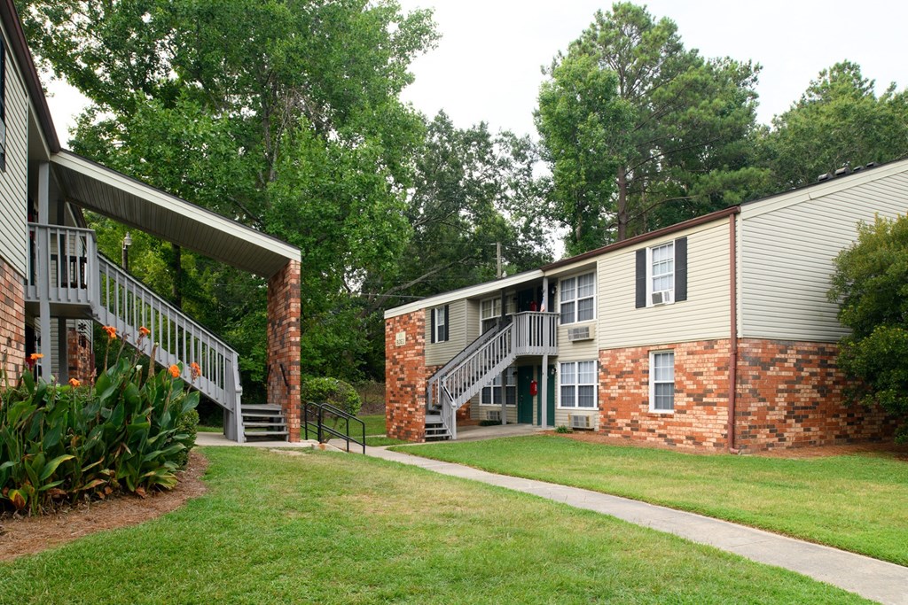 an exterior view of a building with a porch and a walkway