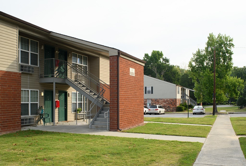 an apartment building on the corner of a sidewalk
