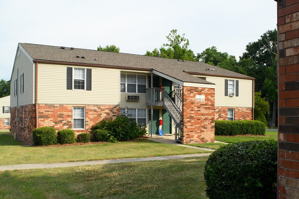 an apartment building with a person walking up the stairs