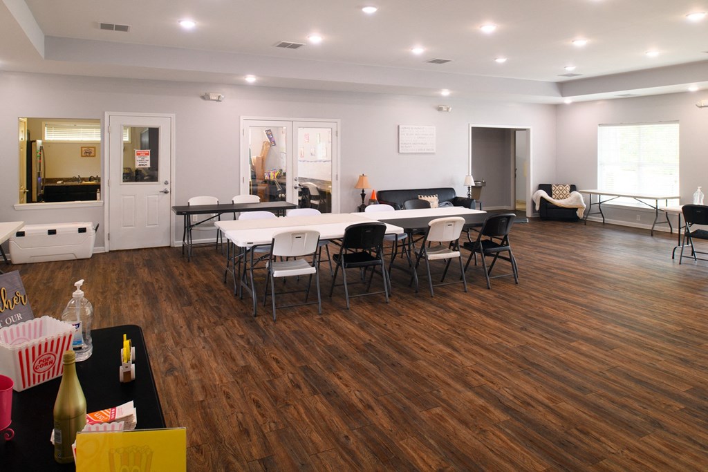 a conference room with a table and chairs in the center of it