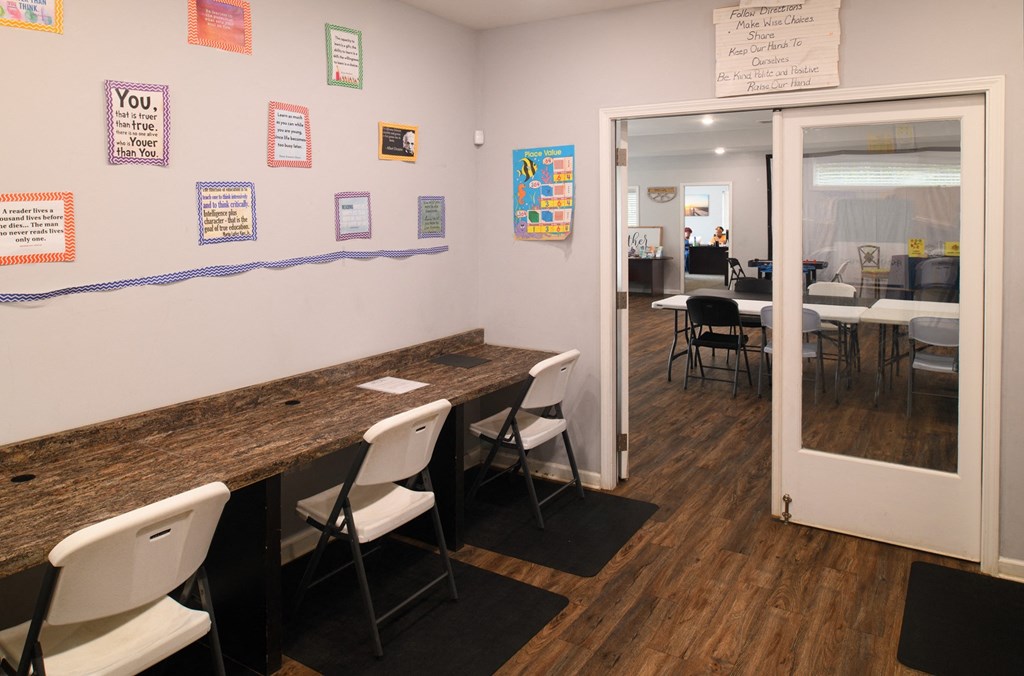 a dining room with tables and chairs and a door to a restaurant