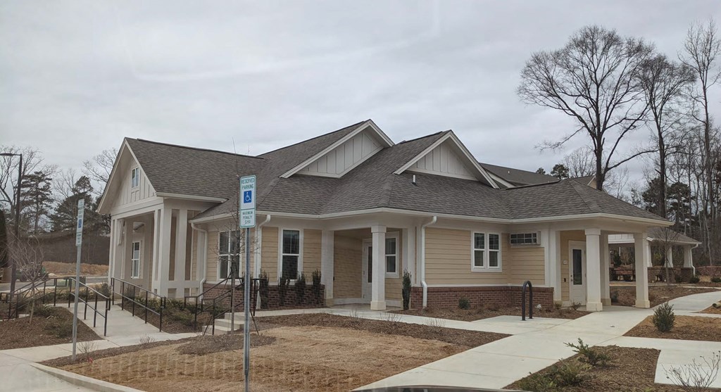 a house with a porch and a sidewalk in front of it