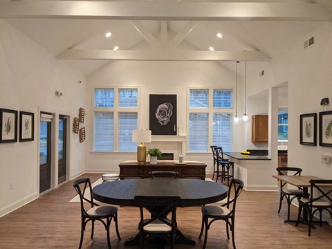the view of a dining room with a table and chairs and a kitchen