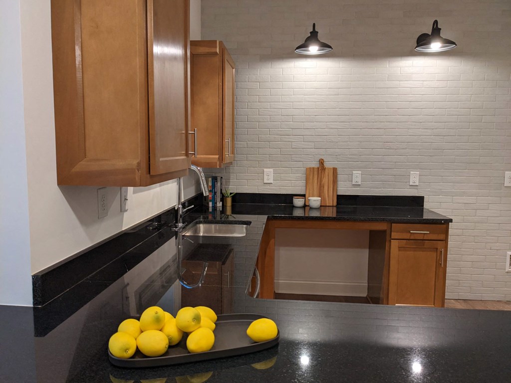 a kitchen with a tray of lemons on the counter