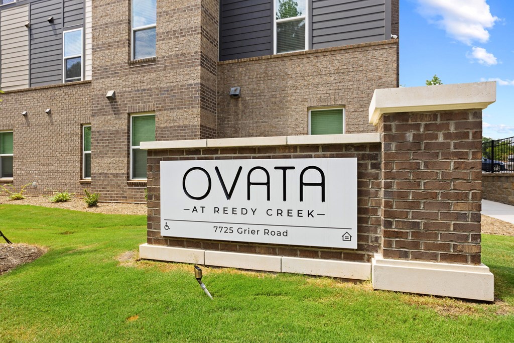 A sign that reads Ovata at Reedy Creek in front of Ovata at Reedy Creek Senior Apartments in Charlotte NC.