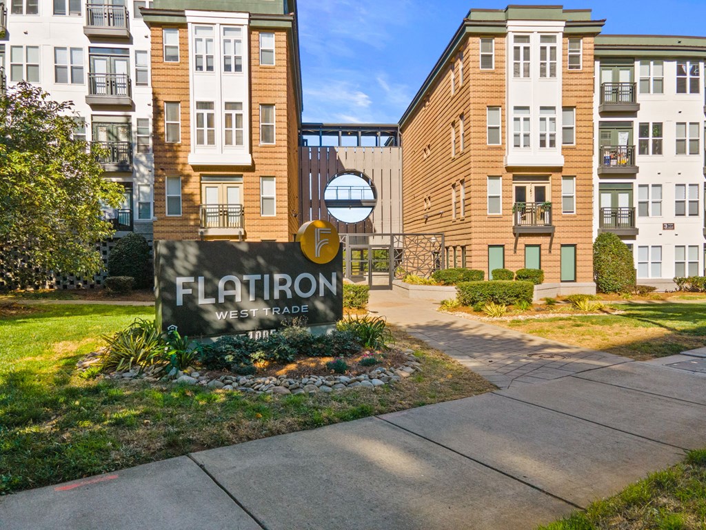 Flatiron West Trade Apartments exterior with monument sign and elevated walkway