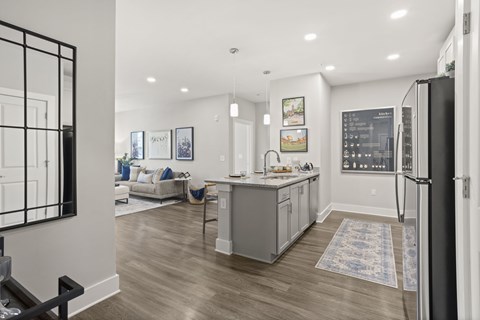 A modern kitchen with a refrigerator on the right side.