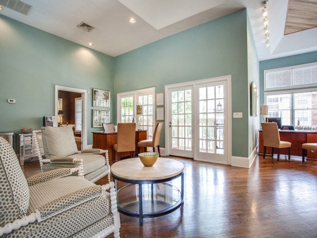 A living room with a couch, chairs, and a coffee table.
