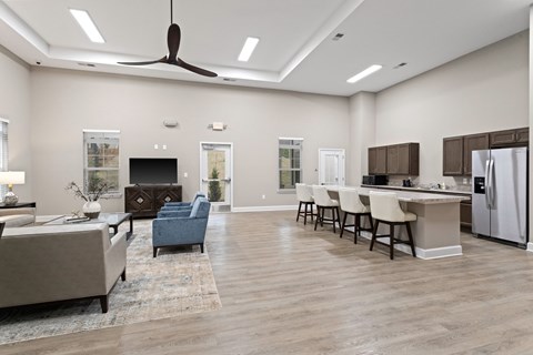 A spacious kitchen and living room with a fireplace and a dining table set up.