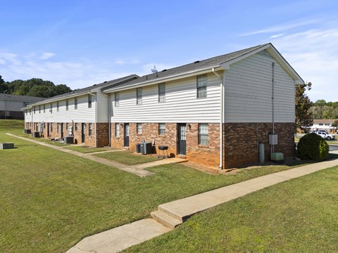 A long building with a brick section in the middle.