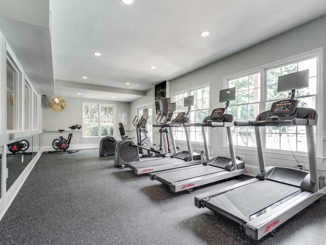 A spacious home gym with treadmills and exercise bikes.