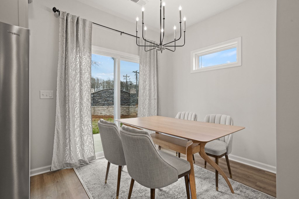 a dining room with a table and chairs and a window