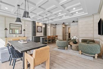 A modern dining room with a wooden table and chairs.