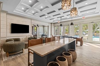 A modern living room with a flat screen TV mounted on the wall.