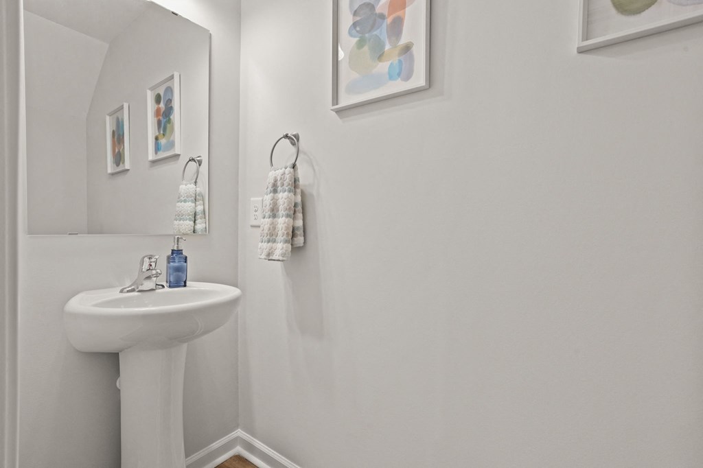 a small bathroom with a sink and a mirror