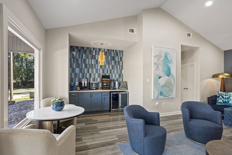 A living room with a blue chair and a white table.