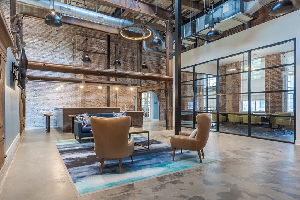 a living room with a couch and chairs and a fireplace