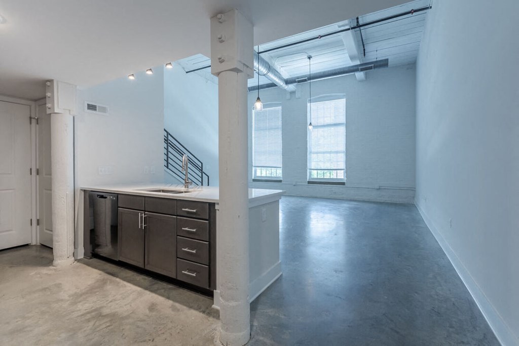 an empty room with a sink and a window