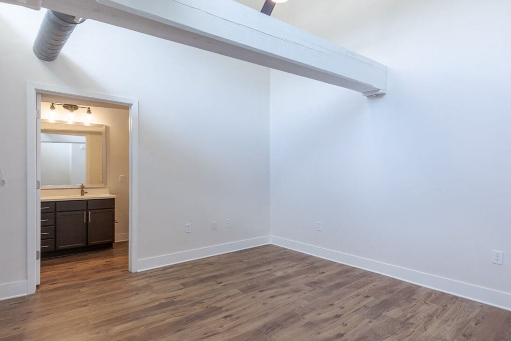 a living room with white walls and a wooden floor