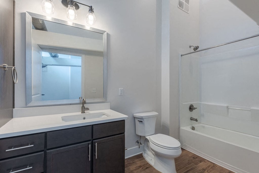 a bathroom with a sink toilet and a mirror