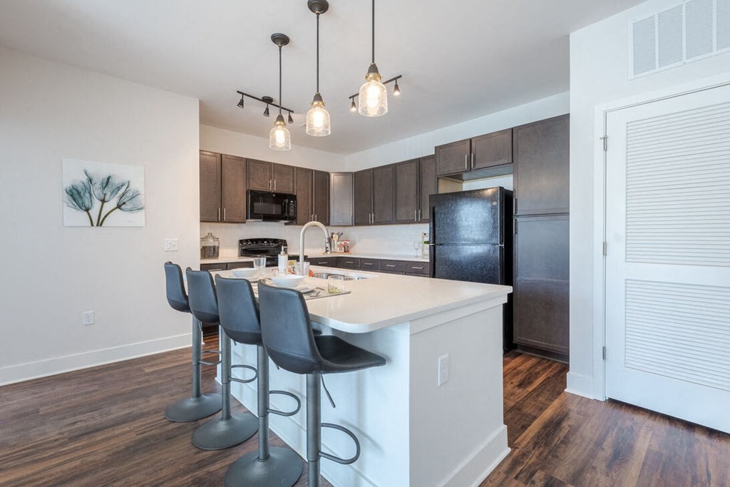 a kitchen with an island and bar stools