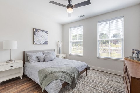 a bedroom with a bed and a ceiling fan