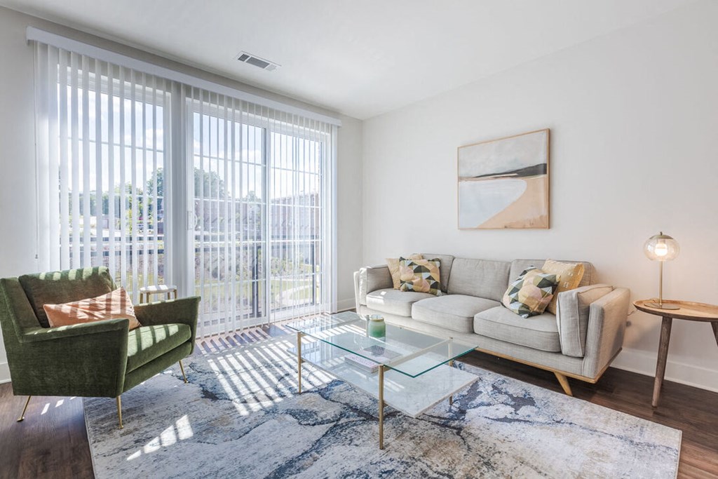 a living room with a couch and a glass coffee table
