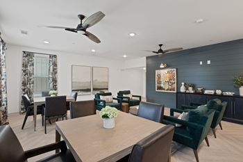 A dining room with a table and chairs.