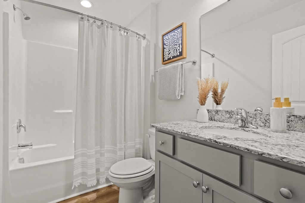 a bathroom with a shower and a sink and a toilet