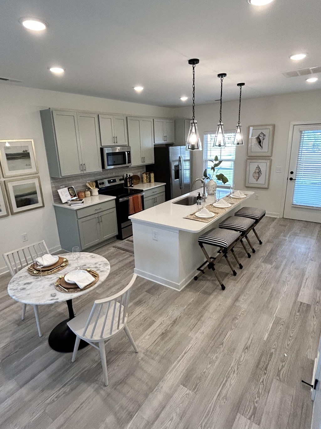 a view of a kitchen and dining area with a table and chairs
