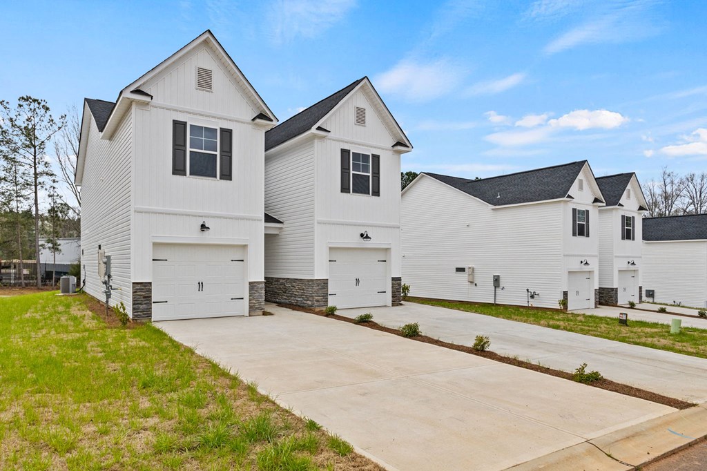 a white house with a driveway in front of it