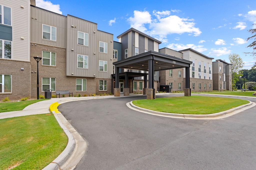 Ovata at Reedy Creek Senior Apartments in Charlotte NC Exterior view of entrance and covered entry drive