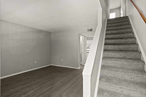 A room with a staircase leading to the upper floor.