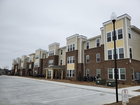 Apartment complex with a no parking sign in front.