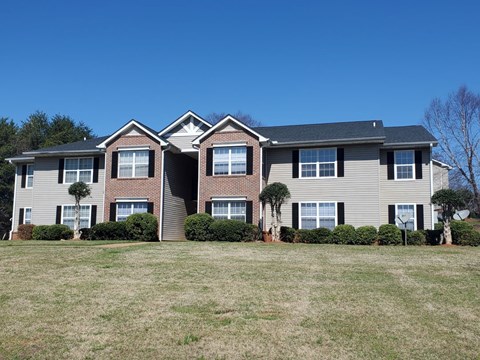 a large house with a yard in front of it