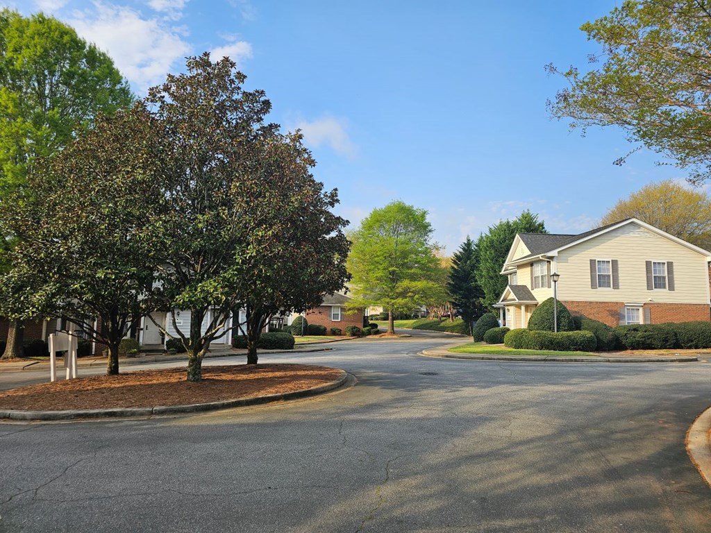 a street in a neighborhood with houses and trees