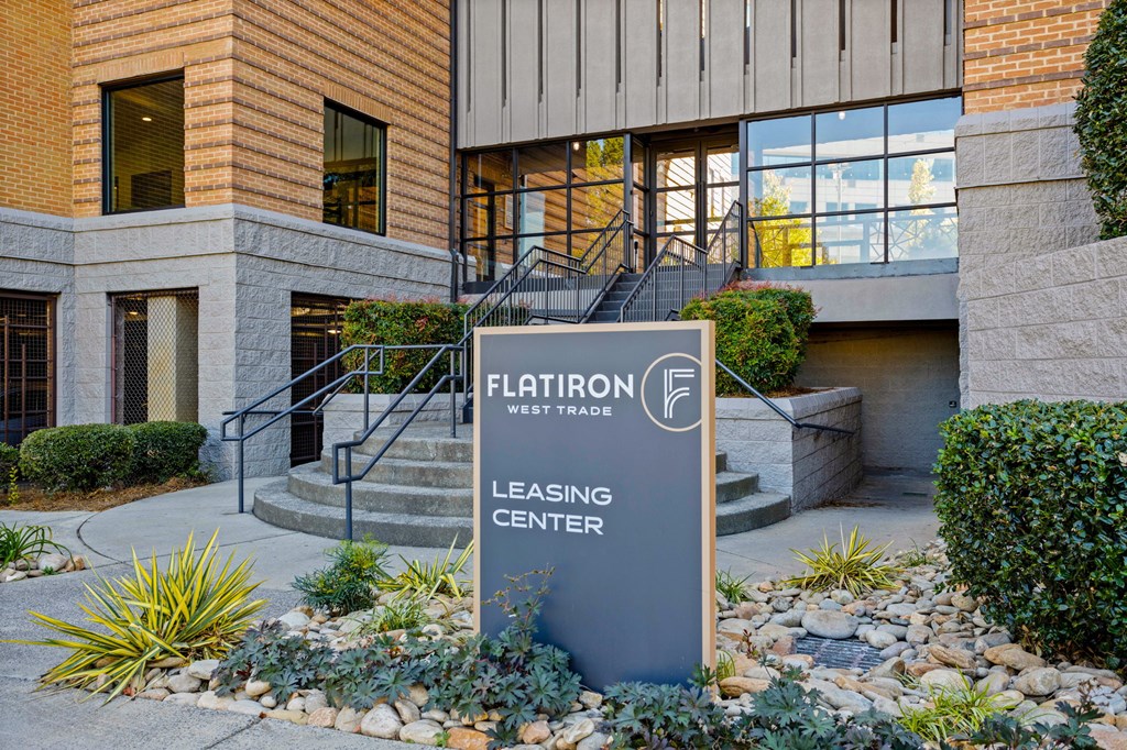 Flatiron West Trade Apartments picture of sign reading "Leasing Center" in front of covered walkway