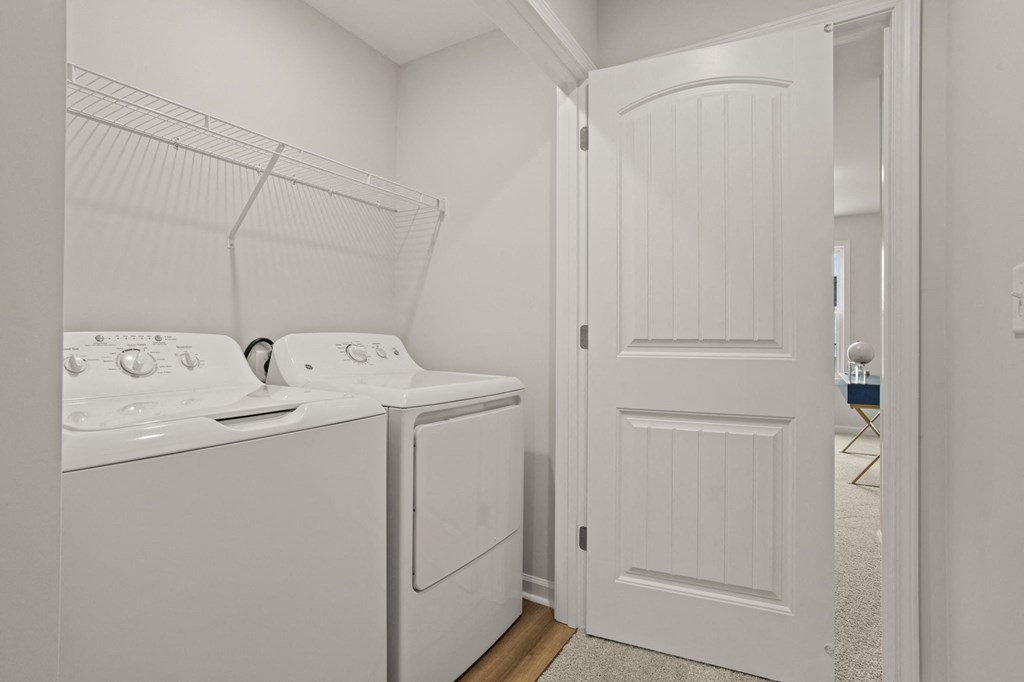a washer and dryer in a laundry room with a white door