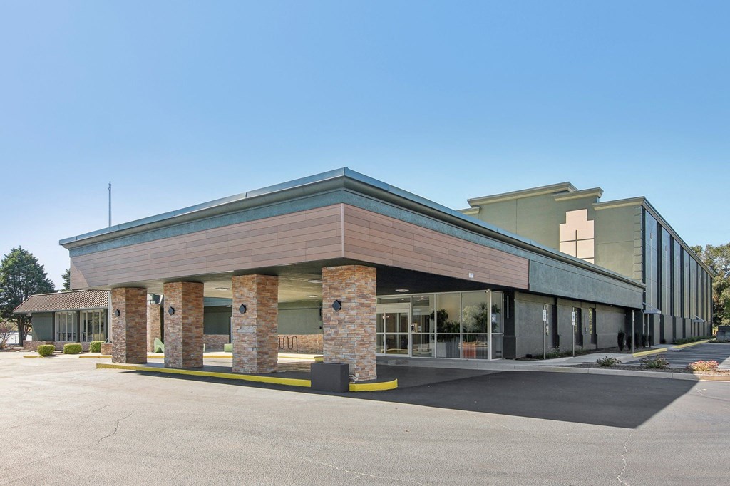 the front of a building with brick pillars