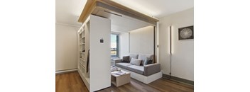 a living room with a couch and a book shelf