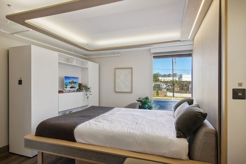Greenville, SC Studios For Rent | Flathouse Studios | Bedroom with Ori Expandable Bed, Pocket Closet, and Large Window.