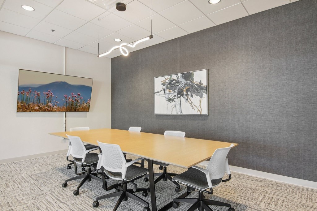 a conference room with a long table and chairs