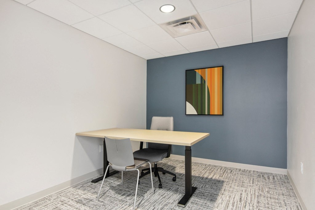 a meeting room with a table and chairs