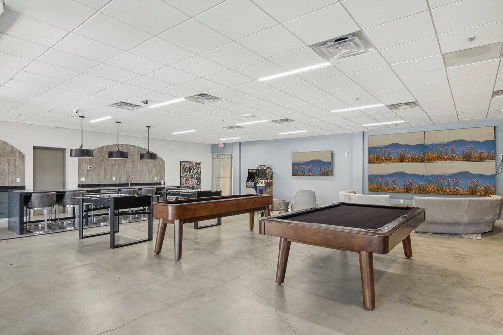 1 Bedroom Apartments in Greenville, SC | Flathouse Studios | Gaming Lounge with Foosball, Shuffleboard, Billiards, and Full Swing Golf Simulator.