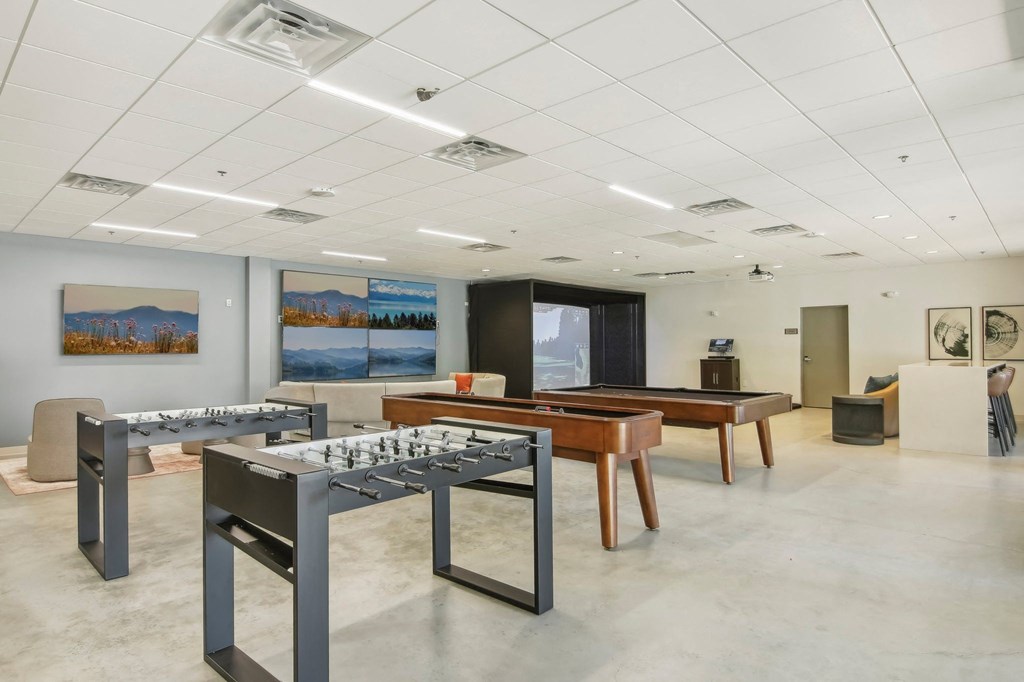 a conference room with tables and chairs and paintings on the wall