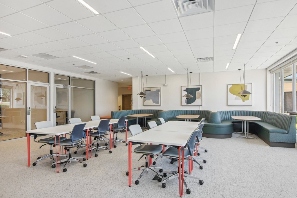 a large room with tables and chairs and couches