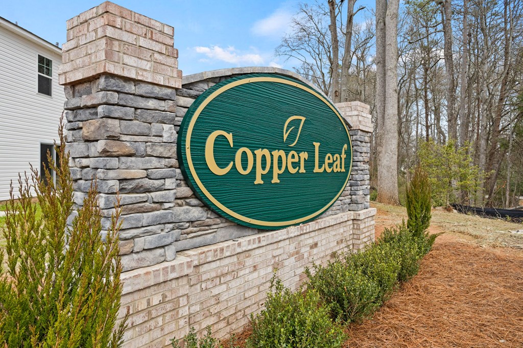 a sign for cooper law on a brick wall with trees in the background