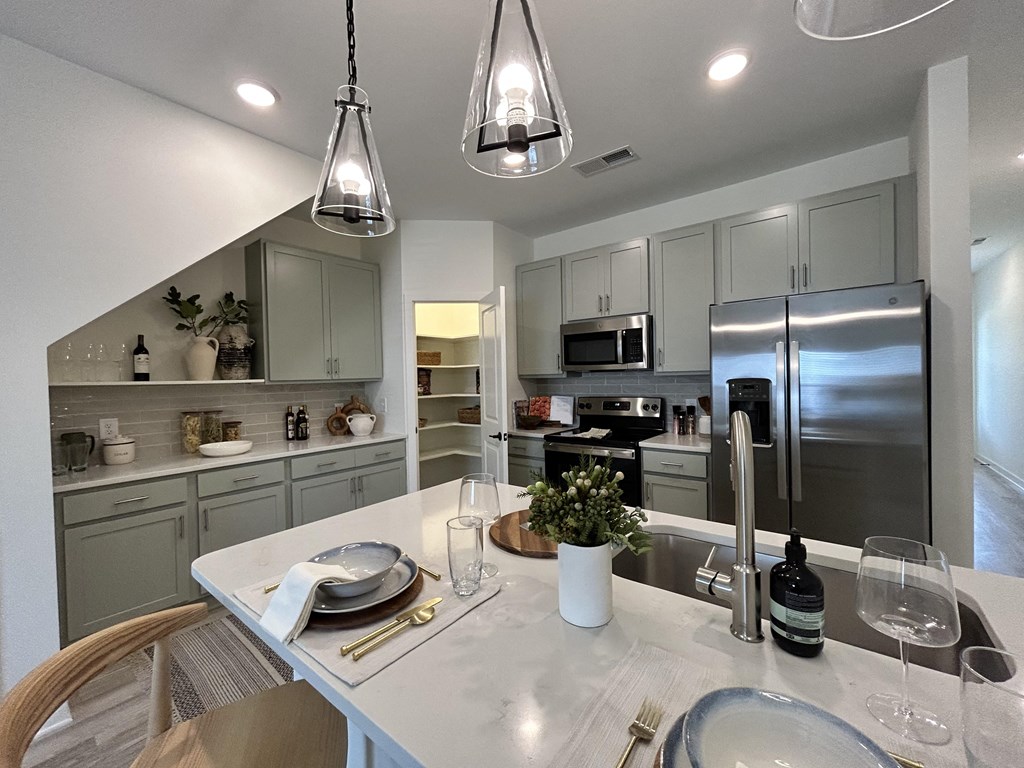 a kitchen with stainless steel appliances and a white counter top