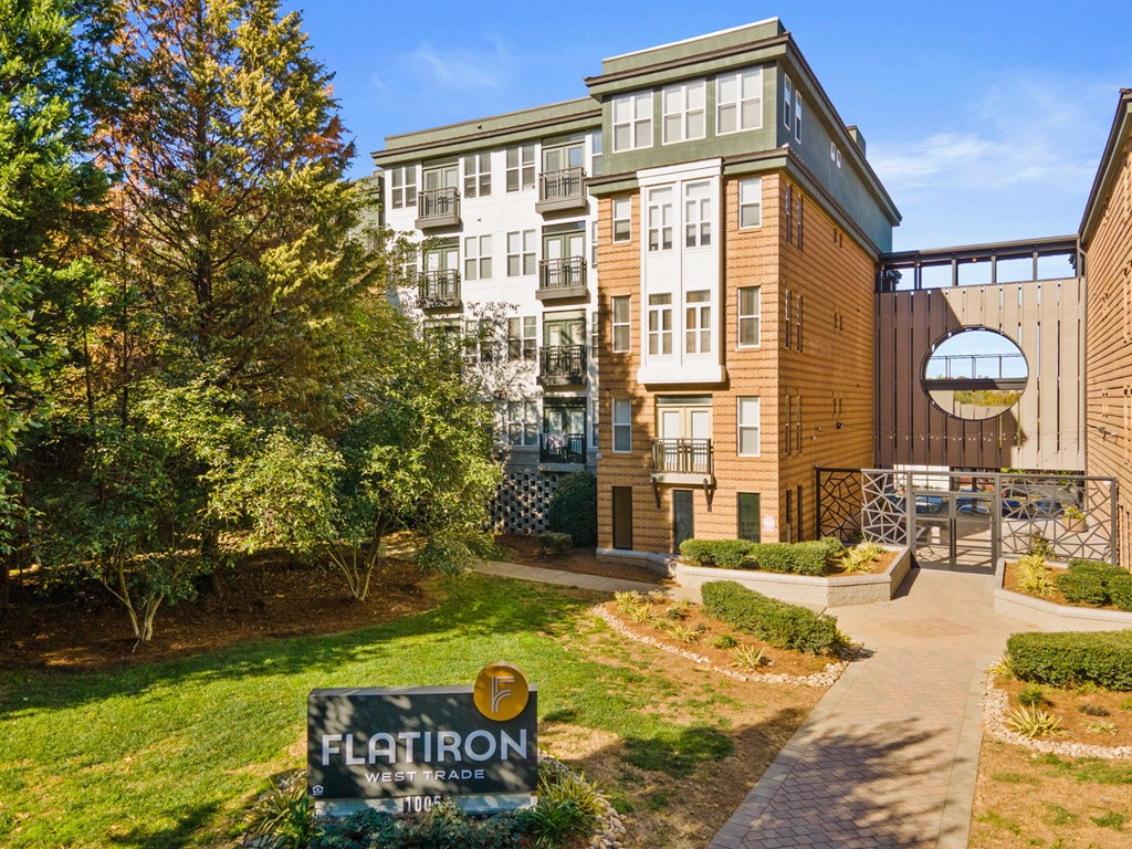Flatiron West Trade Apartments exterior with monument sign and elevated walkway